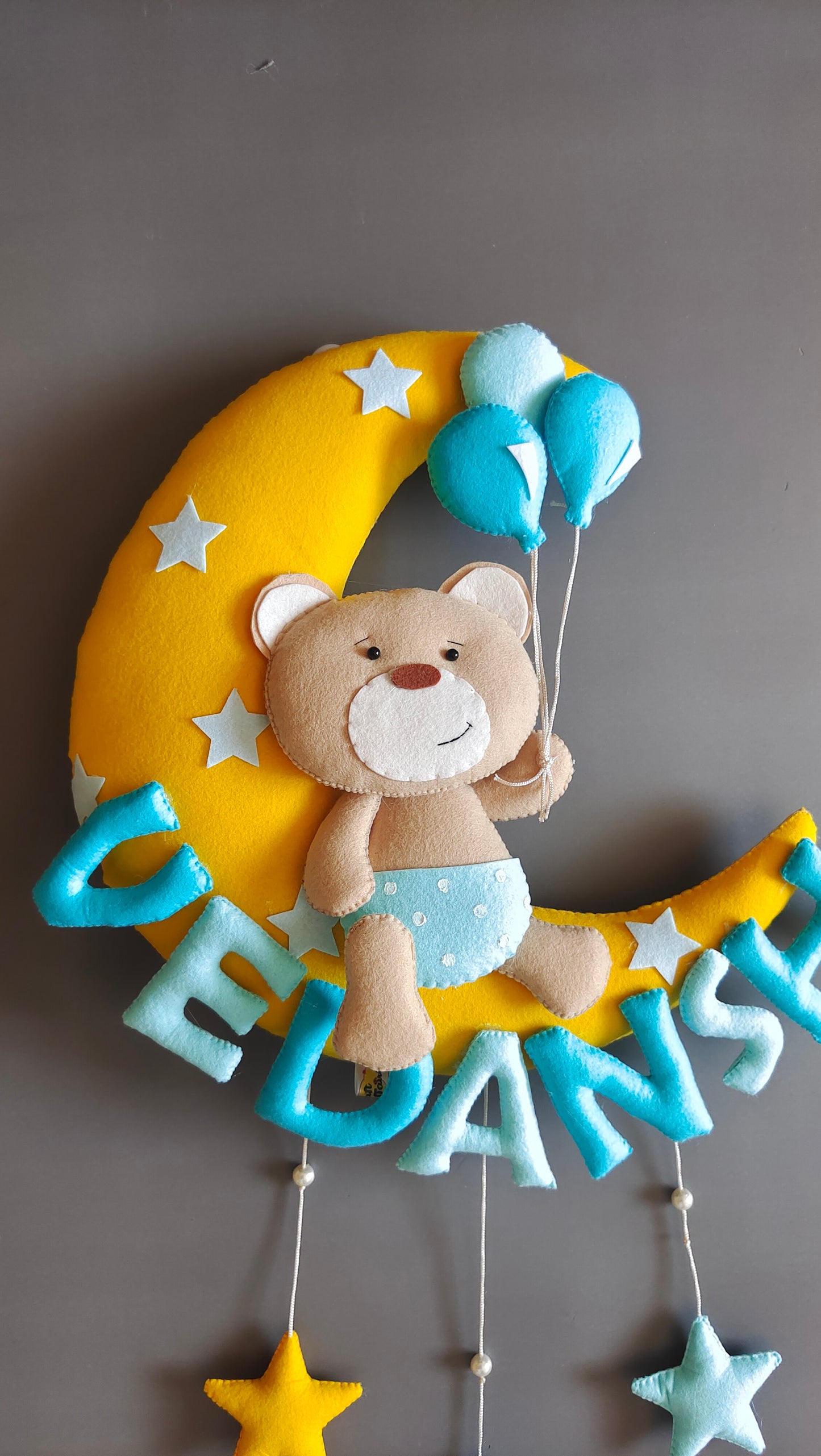 Teddy on moon with balloons
