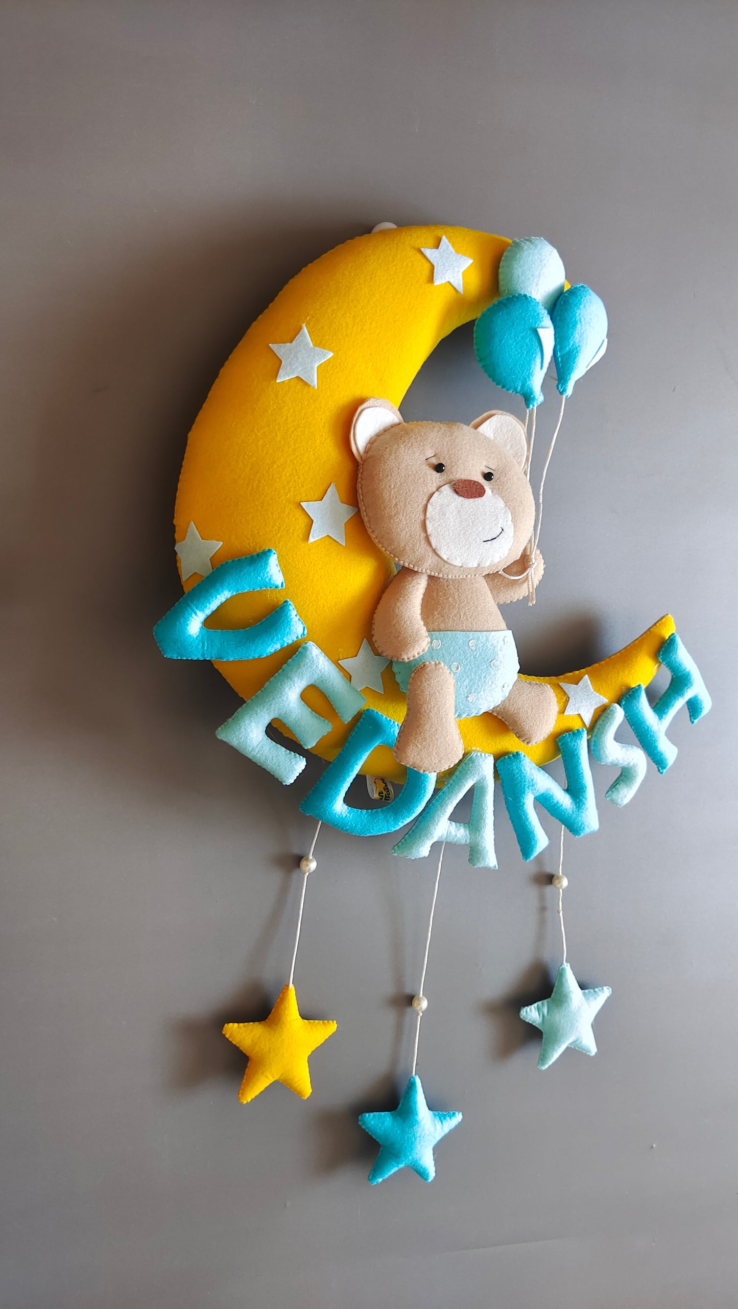 Teddy on moon with balloons