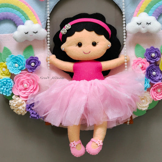 Girl on swing with rainbow