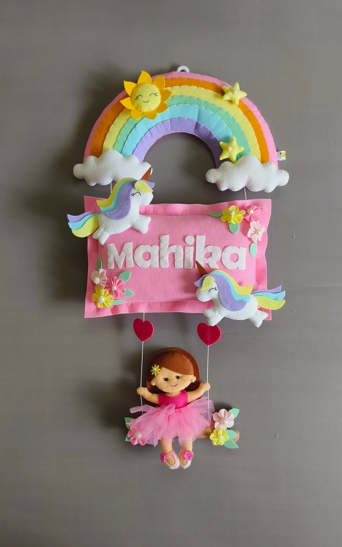 Girl on swing with unicorns