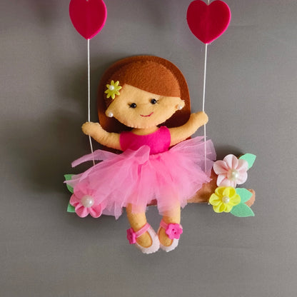 Girl on swing with unicorns