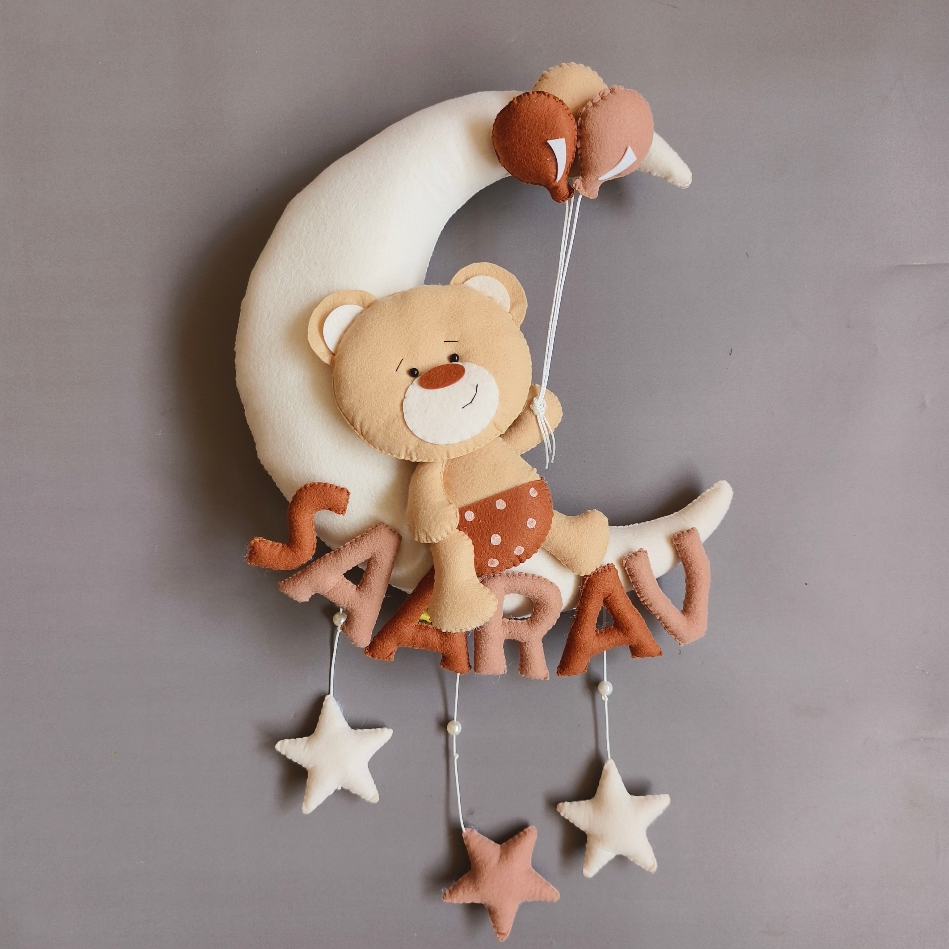 Teddy on moon with balloons
