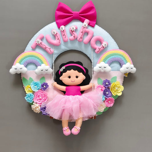 Girl on swing with rainbow